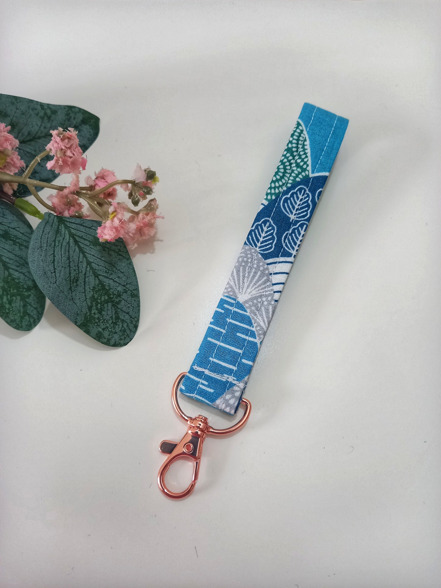 Our fabric wristlet in a lovely blue fabric with retro mountain pattern with sewn in rose gold keyfob.